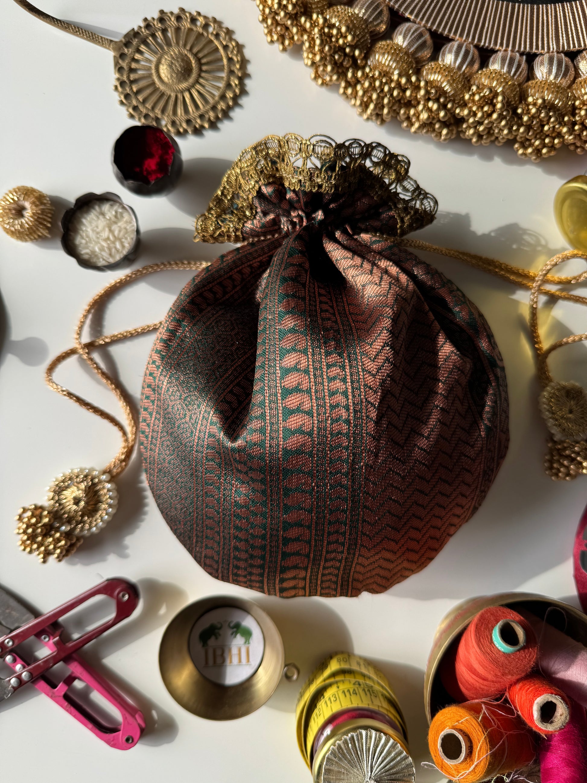 Rekha potli bag featuring vertical geometric lines with a modern traditional design – perfect for weddings, gifting, and festive occasions.