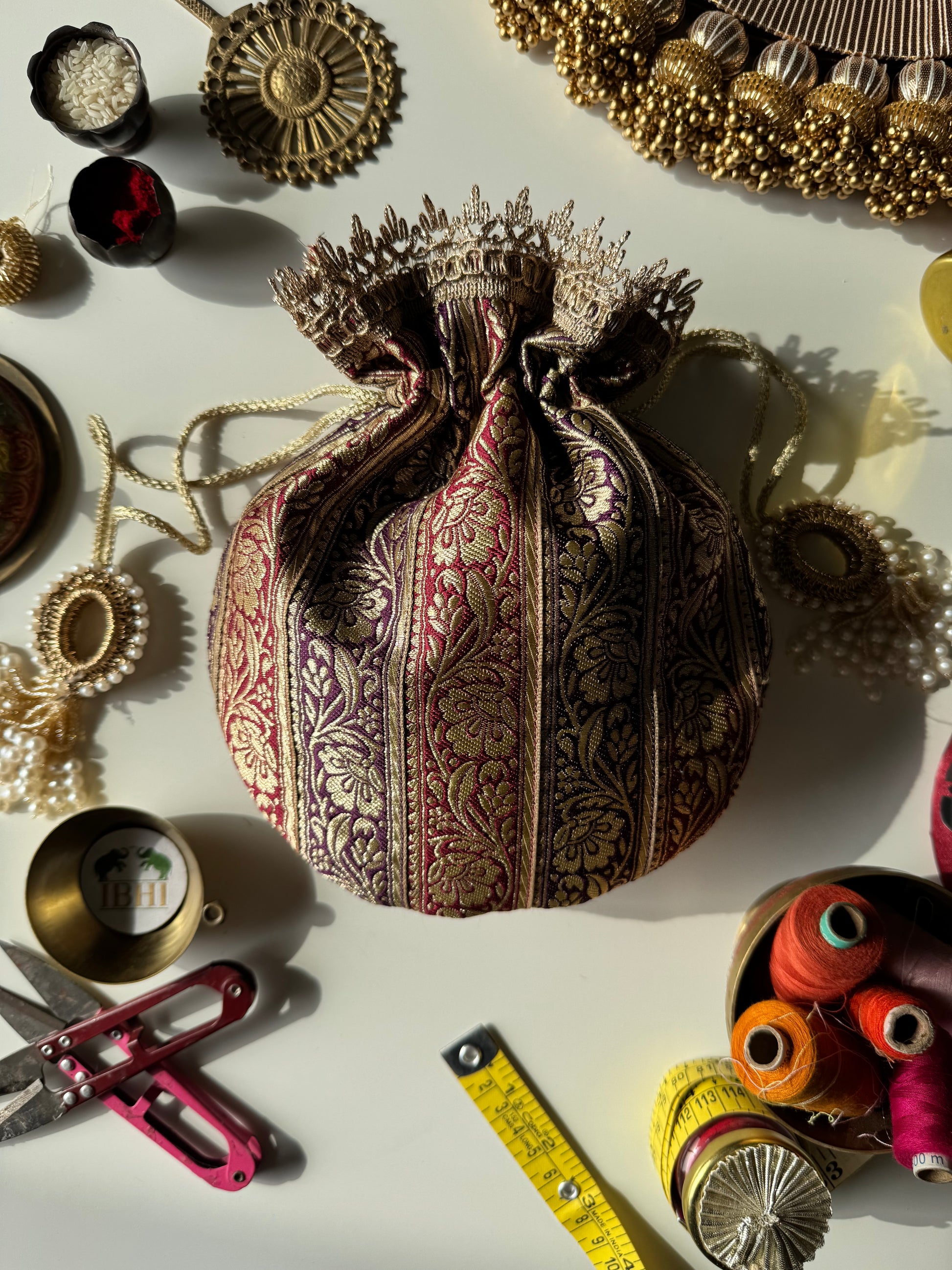 Navy blue and wine potli bag named Raat Ki Rani with zari detailing – perfect for evening wear, wedding favors, and festive gifting by IBHI.