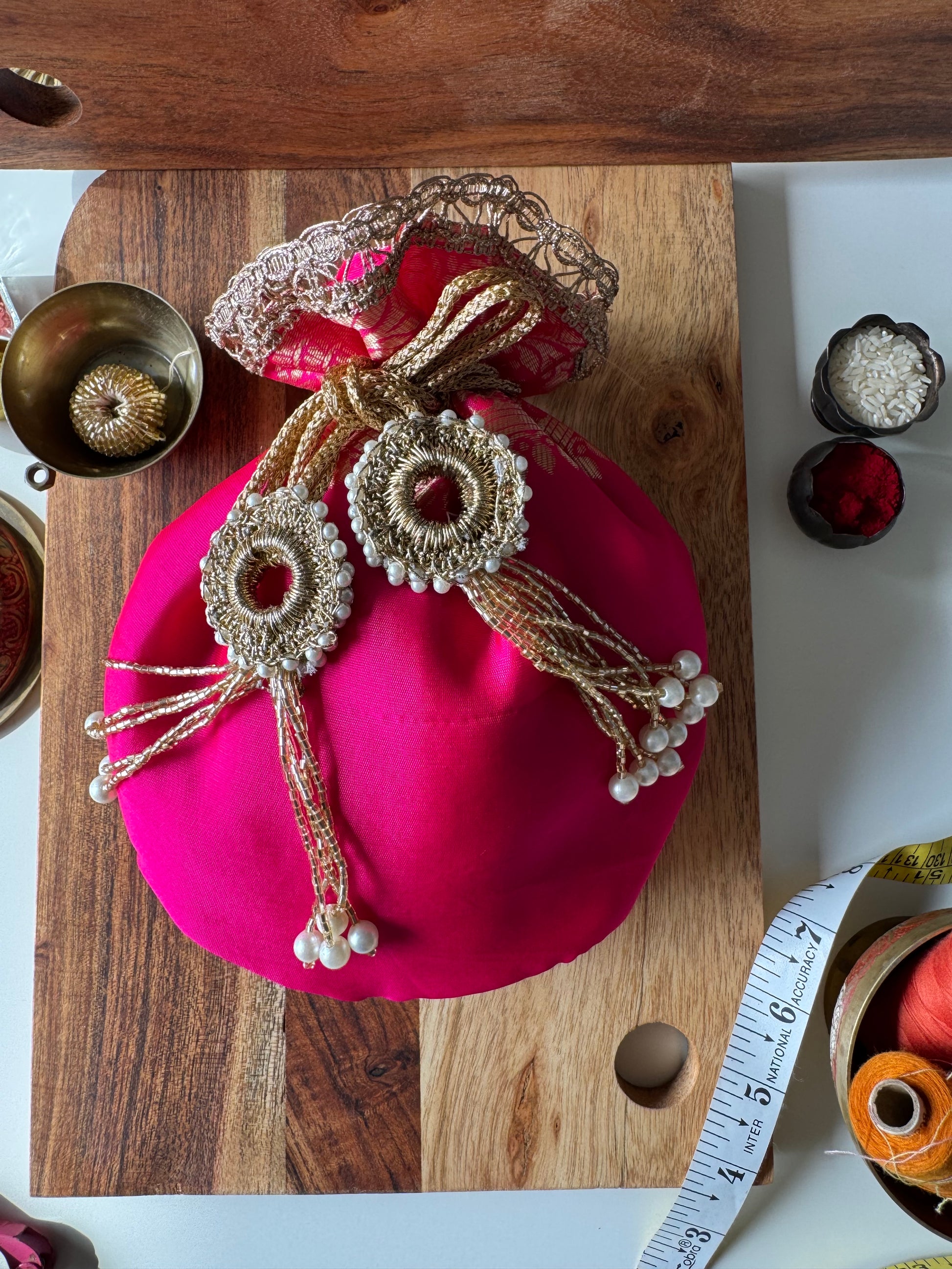 Rani Rang potli bag in rich dark pink color with a royal finish – perfect for weddings, festive favors, and traditional gifting by IBHI.