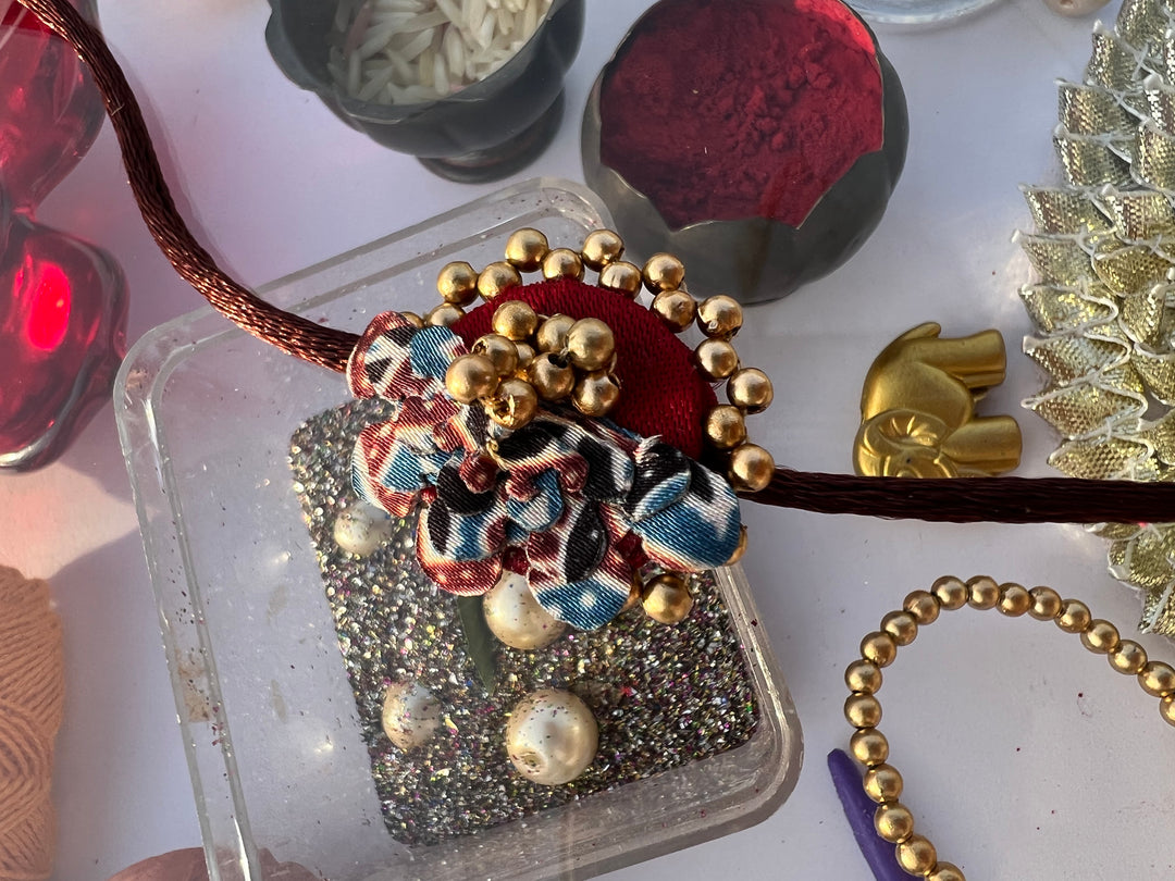 Pink Navratna Patola Half Pollen Enchanted Rakhi