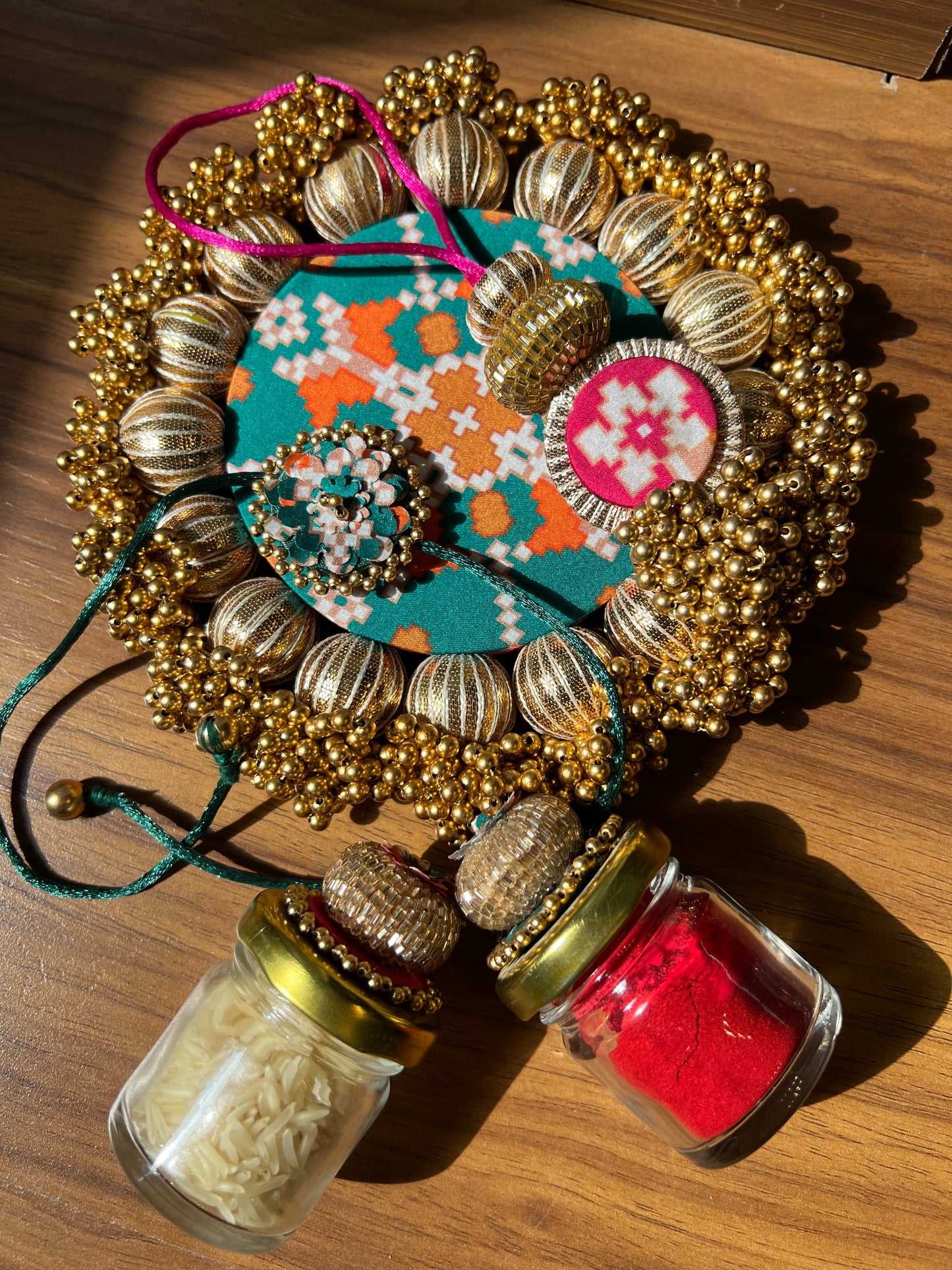 Joker Poker Rakhi set: Bottle Green + Pink Navratna Patola