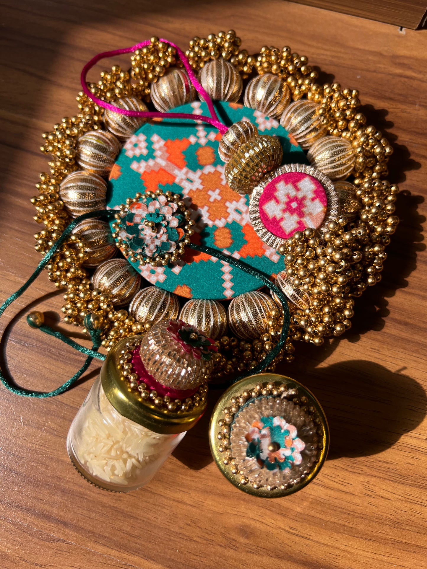 Joker Poker Rakhi set: Bottle Green + Pink Navratna Patola