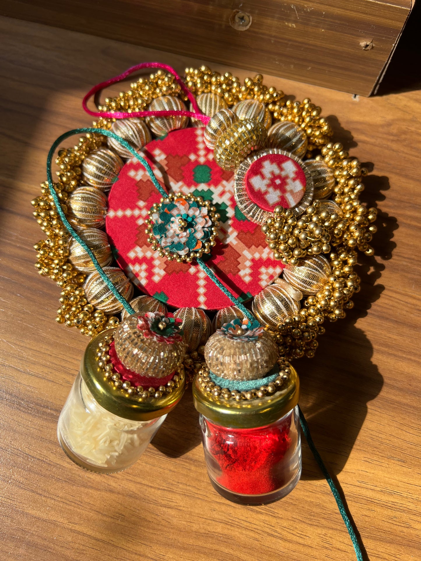 Joker Poker Rakhi set: Bottle Green + Pink Navratna Patola