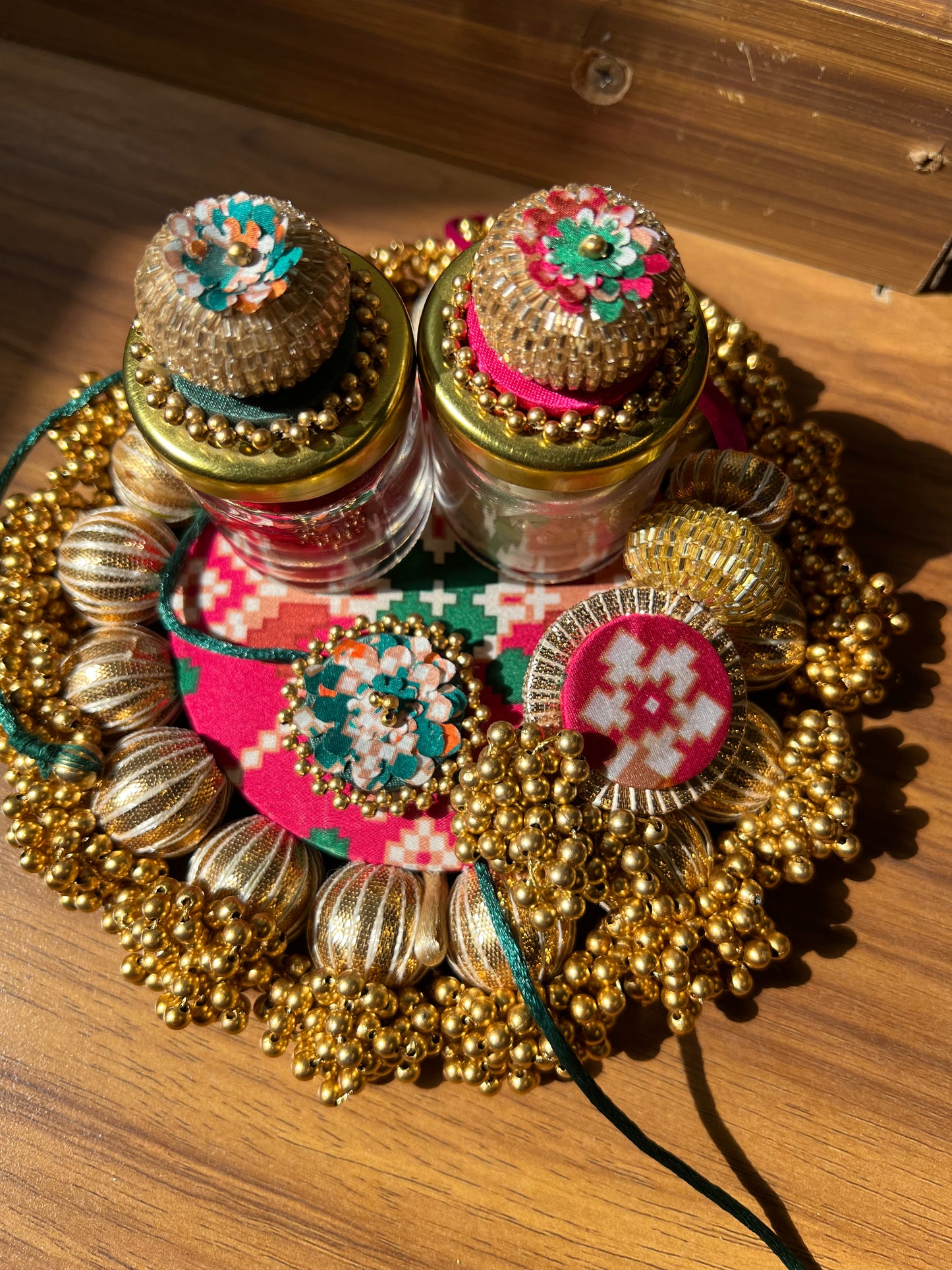 Joker Poker Rakhi set: Bottle Green + Pink Navratna Patola