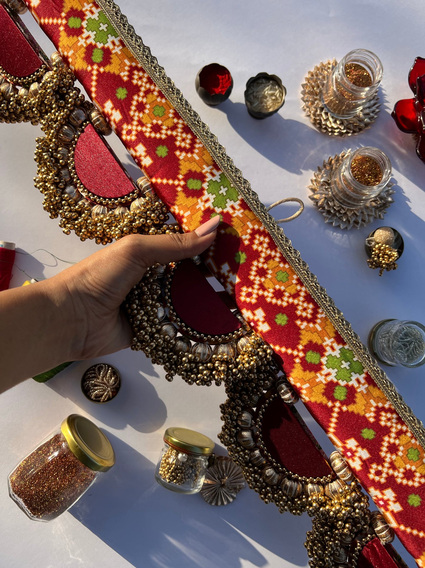THE SLEEK: Maroon Navratna Patola X Solid Beaded Arcs and Inflorescence Divine Pichwai Toran for home decor