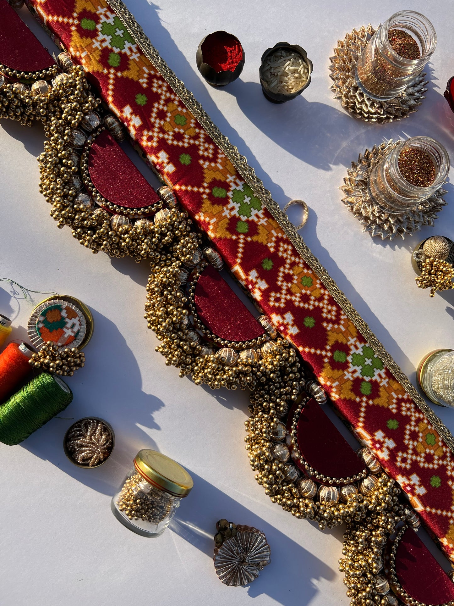 THE SLEEK: Maroon Navratna Patola X Solid Beaded Arcs and Inflorescence Divine Pichwai Toran for home decor