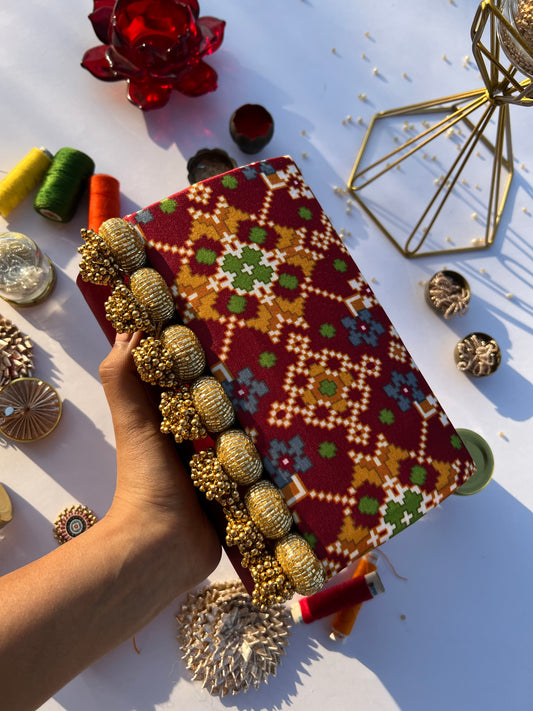Sylphlike Maroon Navratna Patola Micro Beaded X Solid Silk Clutch