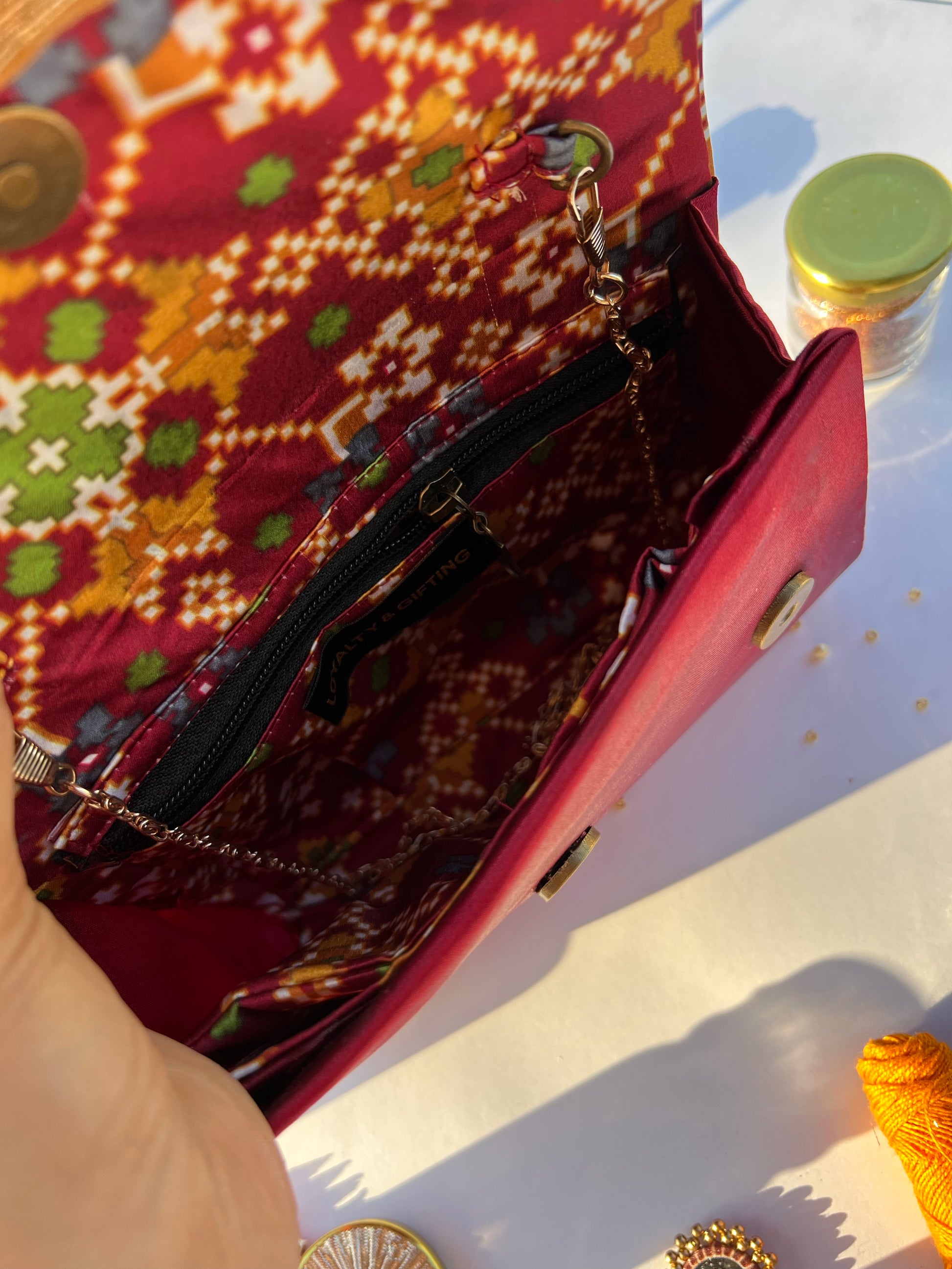 Sylphlike Maroon Navratna Patola Micro Beaded X Solid Silk Clutch