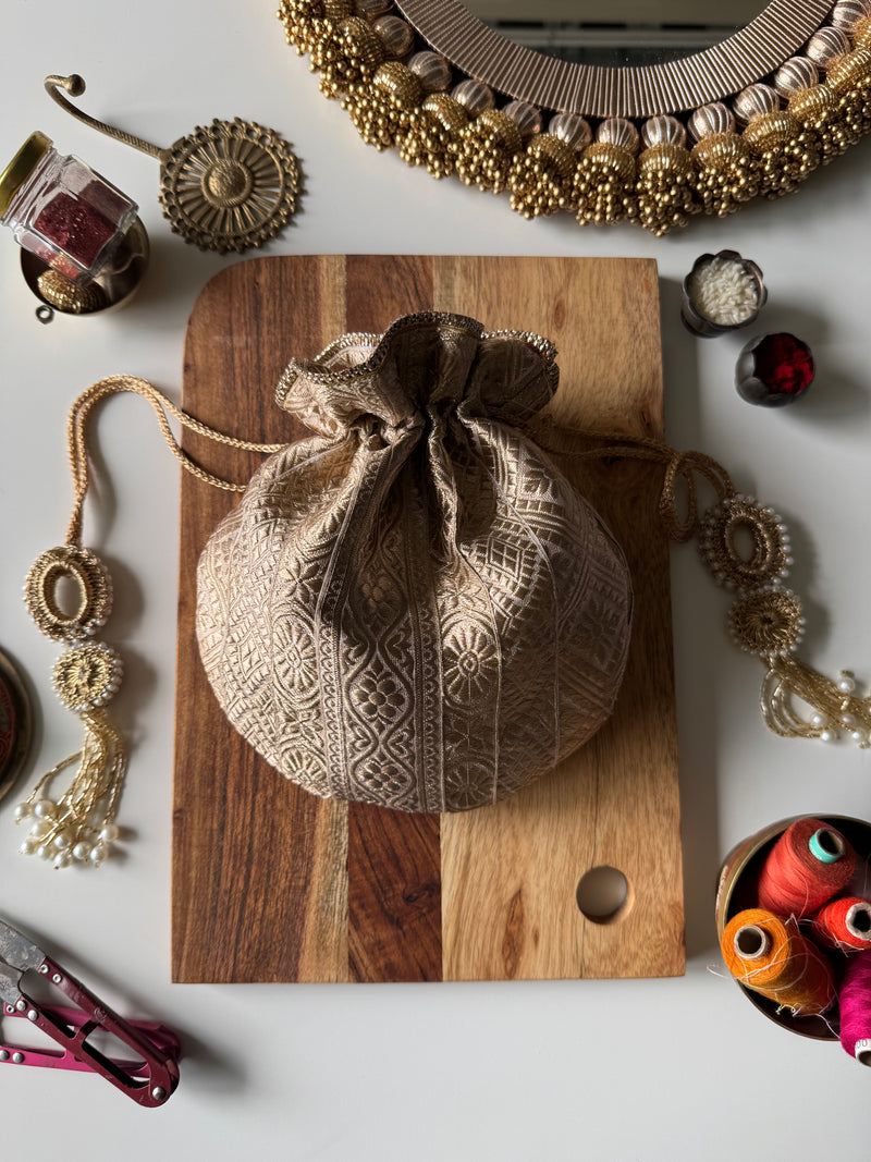 Rose gold potli bag with shimmer finish and drawstring closure – perfect for weddings, gifting, and festive occasions. Goes well with all outfits.

