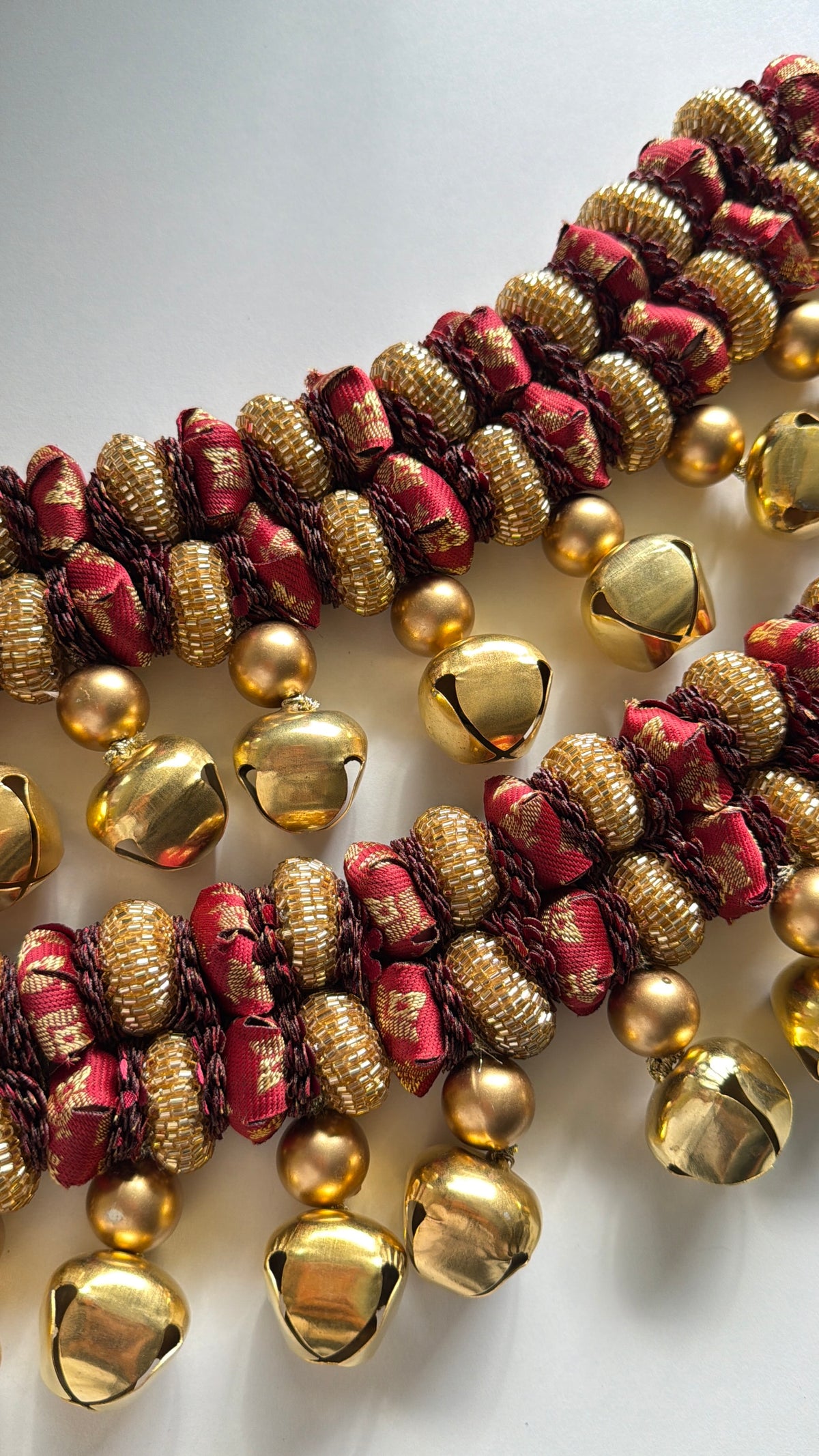 Handcrafted maroon gajra toran with glass beads and dull golden beads