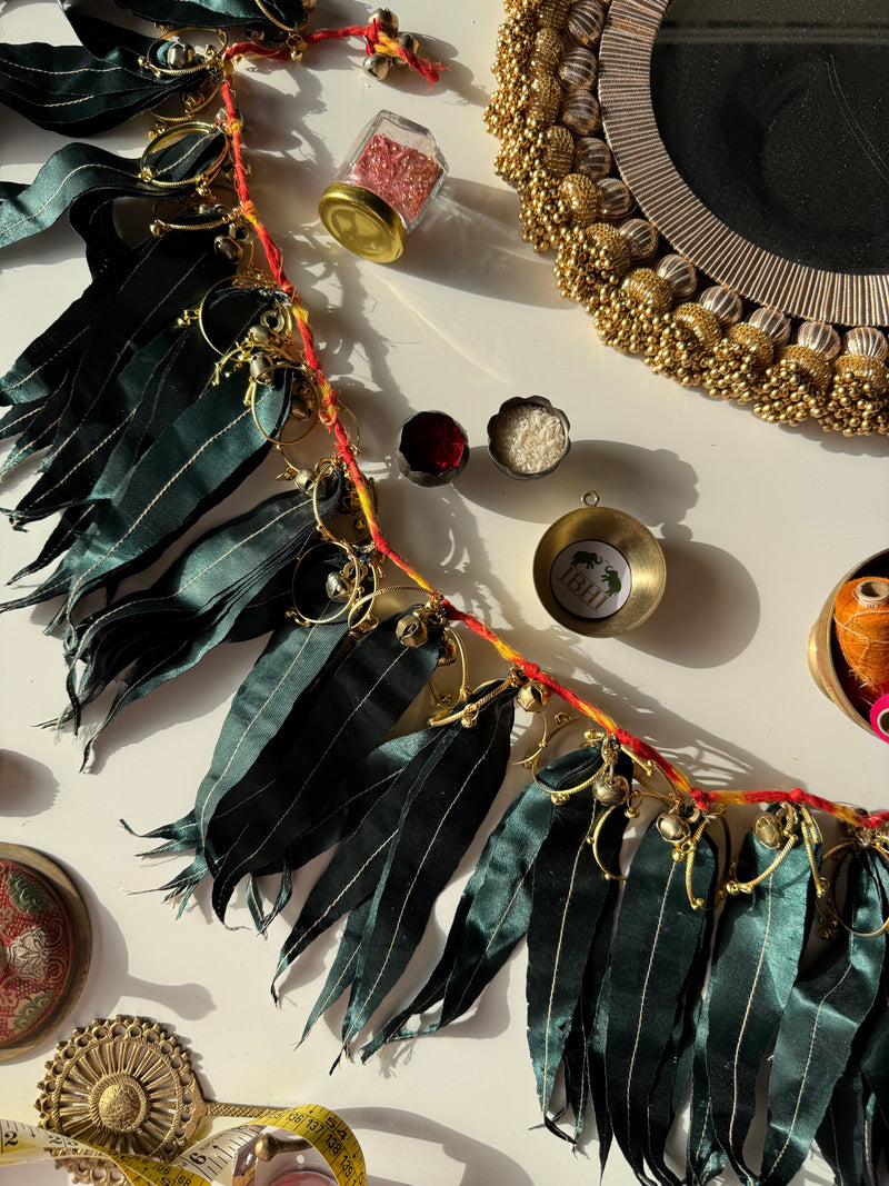 Asopalav leaf toran with fabric leaves and ghungroos – handcrafted Indian door hanging for festive and wedding decor by IBHI.

