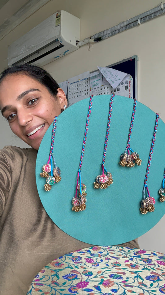 Neelgulabi backdrop by IBHI featuring sea green silk with embellishments, magenta Banarasi fabric, and Paithani-inspired peacock designs

