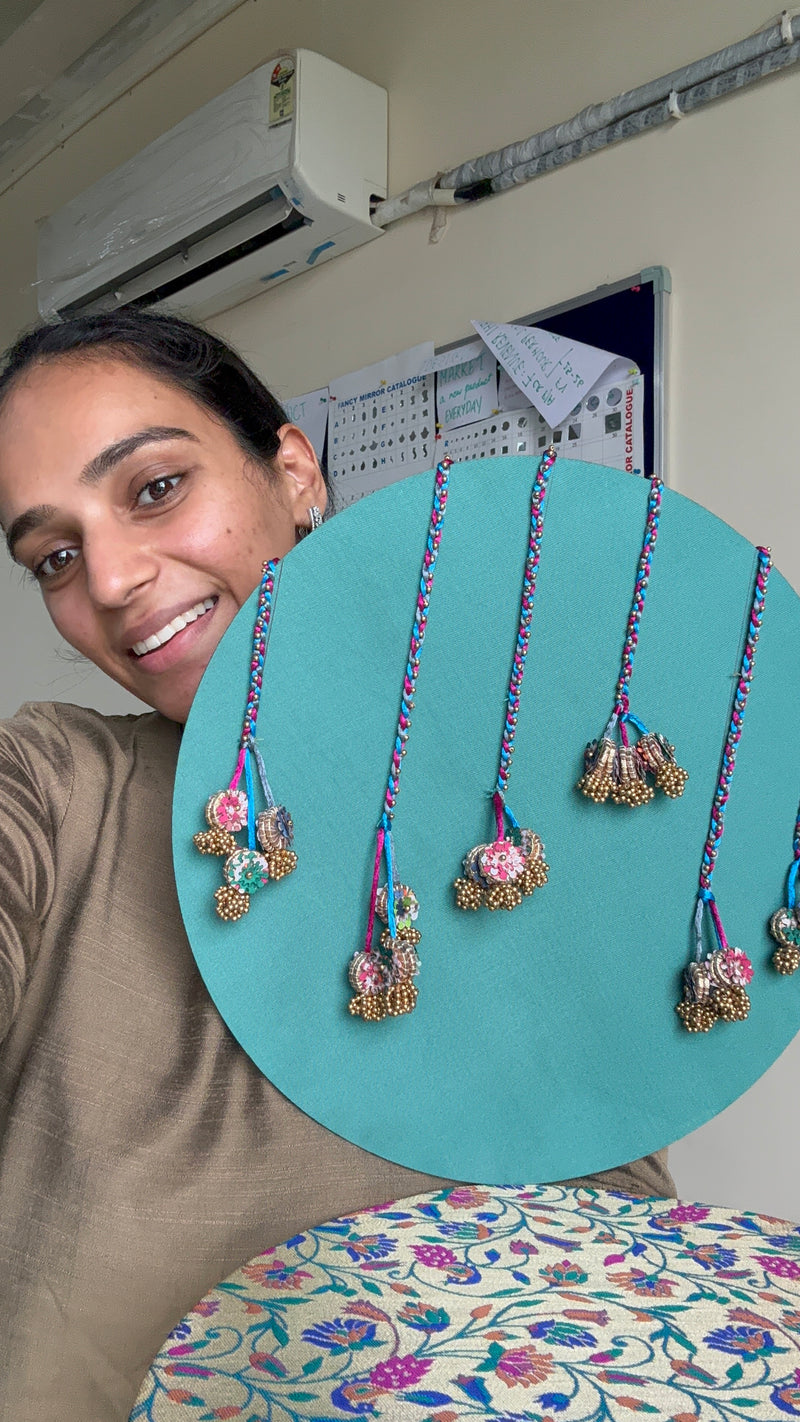 Neelgulabi backdrop by IBHI featuring sea green silk with embellishments, magenta Banarasi fabric, and Paithani-inspired peacock designs

