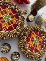Load image into Gallery viewer, Maroon Navratna Patola Beaded Shubh Labh Pallets- Set of two
