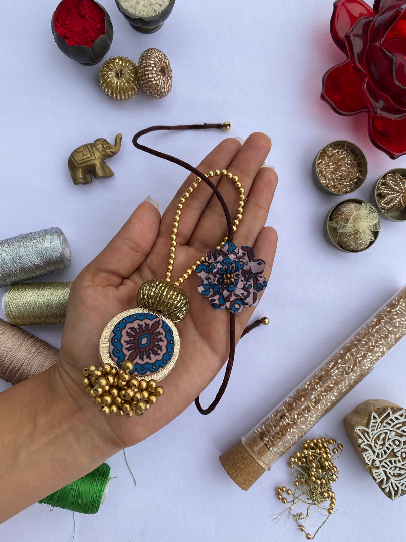 Upended Confluence Intense Ajrakh Stretchable Copper Beads Strand Lumba & Enchanted Rakhi