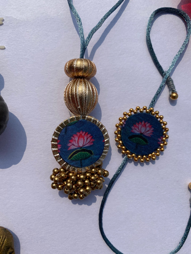 Idiosyncratic Divine Pichwai Couple Rakhi Ensemble II